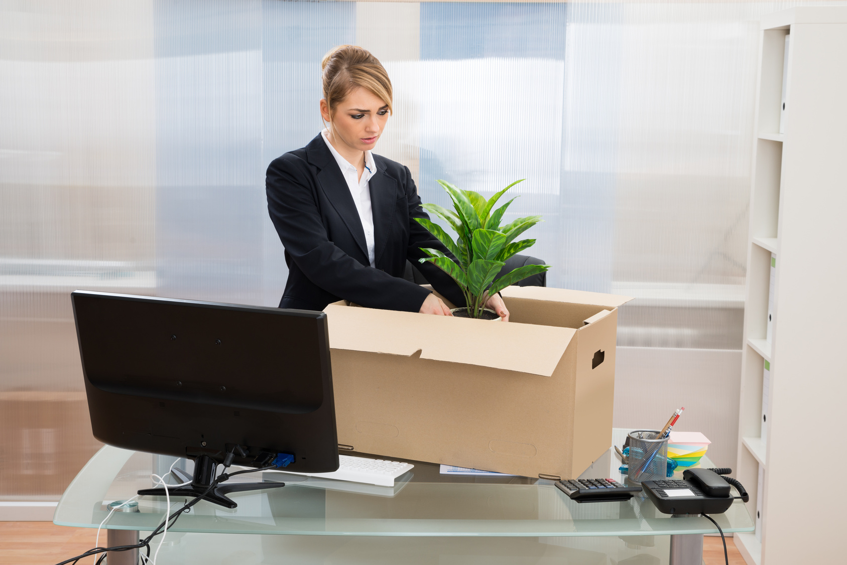 Businesswoman Packing Belongings In Box