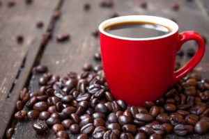 coffee in a red cup on a wooden table