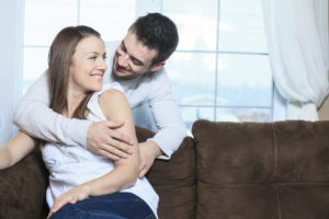 An happy couple at home relaxing in sofa