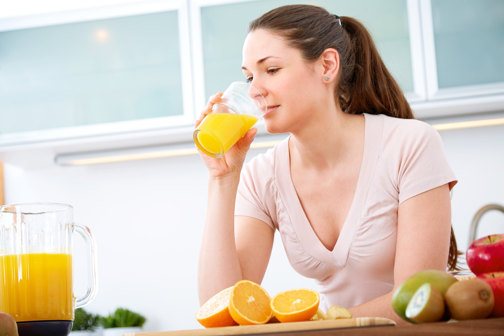 Portrait of young woman drinking orange Juice