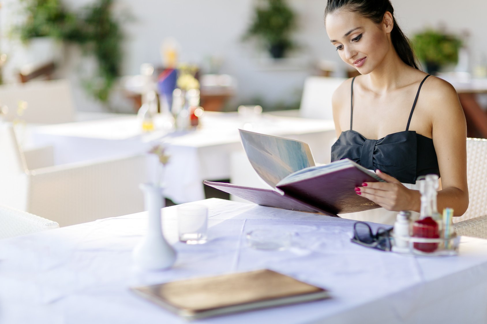 Beautiful woman ordering from menu