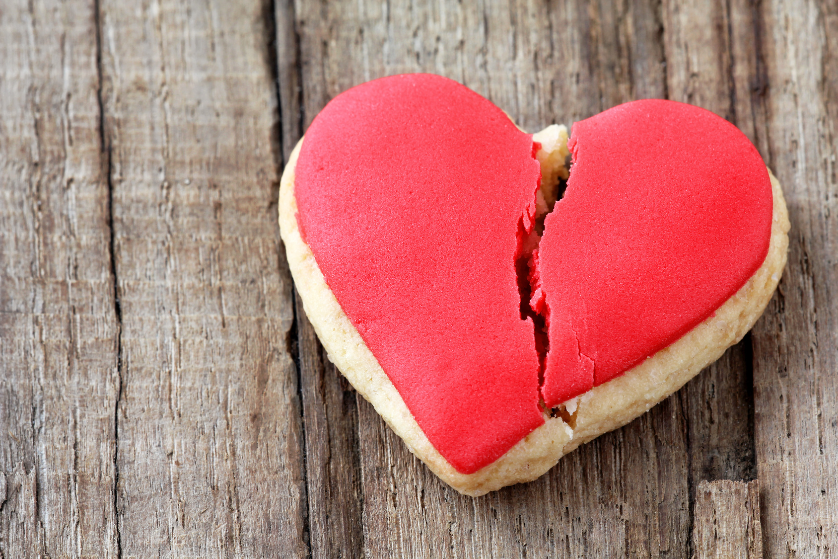 Cracked cookie as a concept of broken heart and breakup
