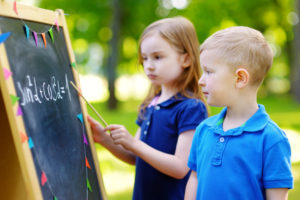 Adorable little girl and her little student