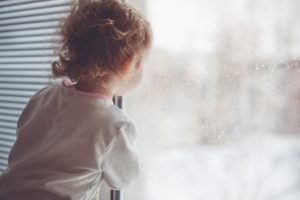 A child looks out the window.