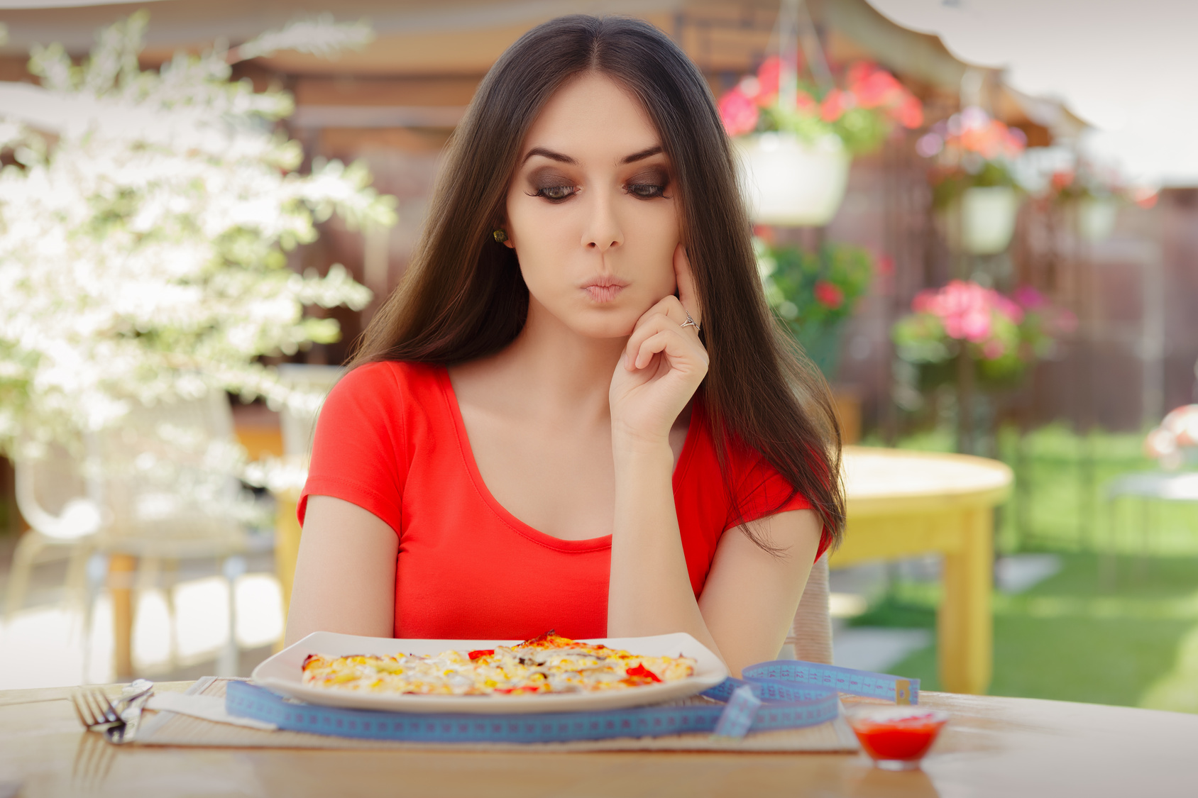 Young Woman Thinking About Eating Pizza on a Diet