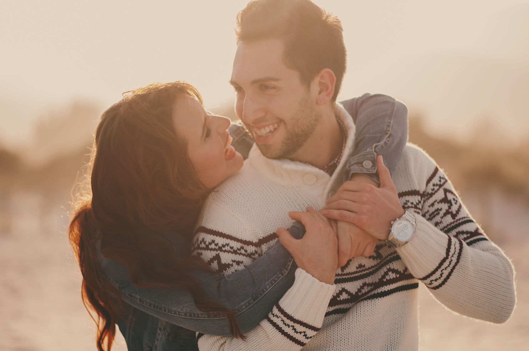 Lovely young couple on the sunset beach, selective focus