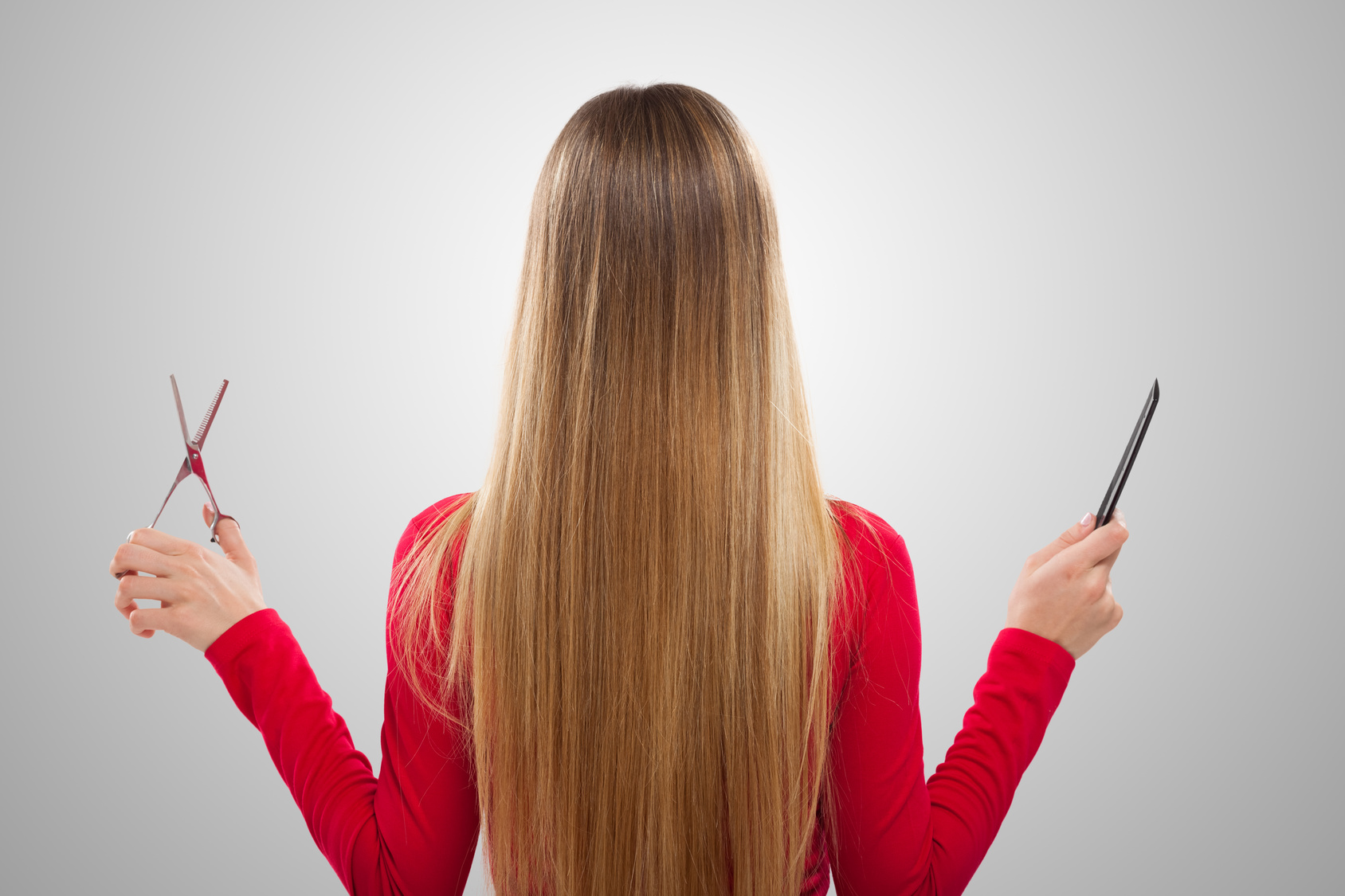 Woman holding comb and scissors