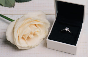 Engagement Ring In gift Box and flowers. Love, Wedding, Marriage concept.