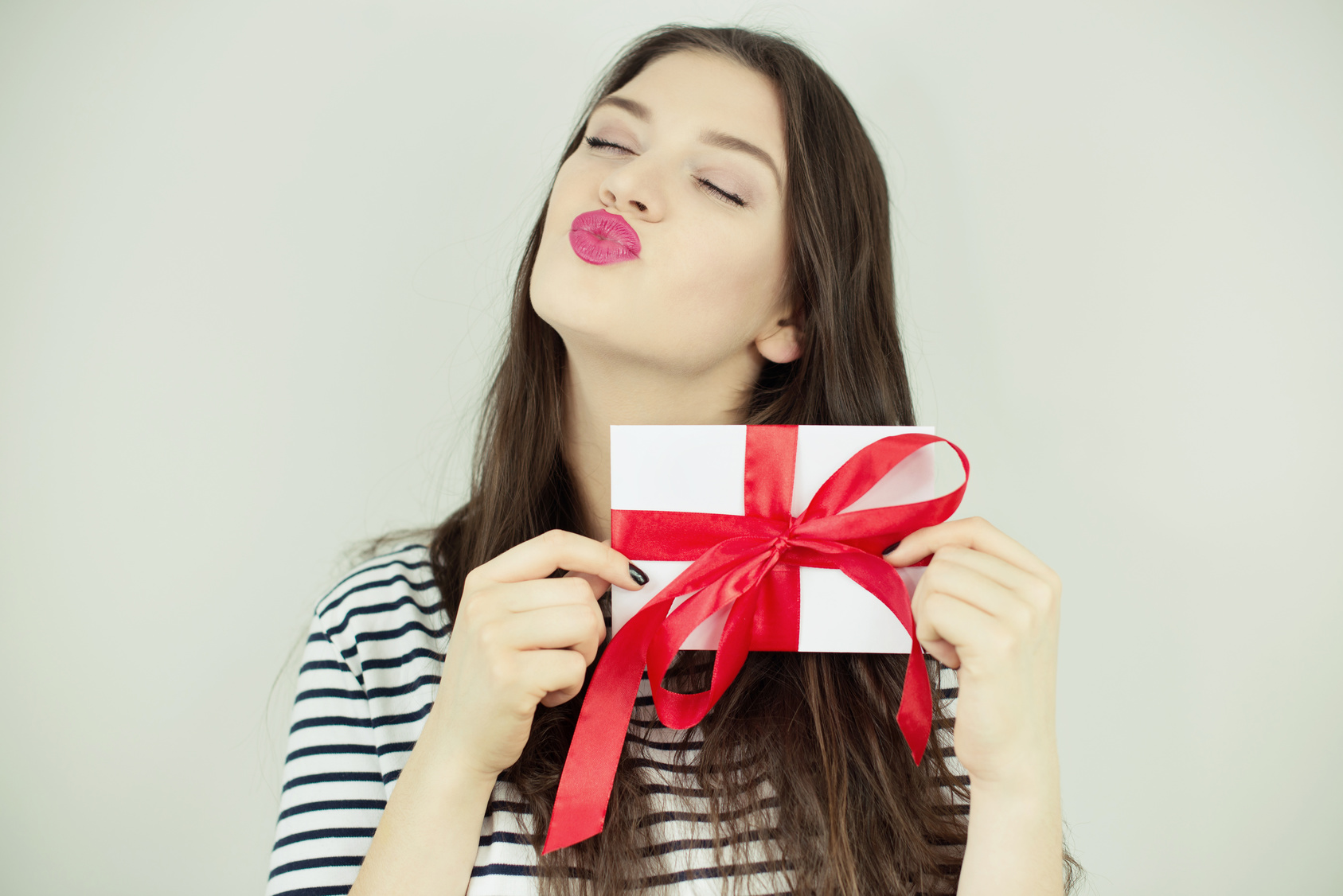 Happy girl holding letter with ribbon