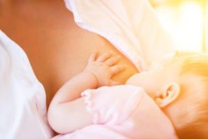 Mother nursing baby by breastfeeding