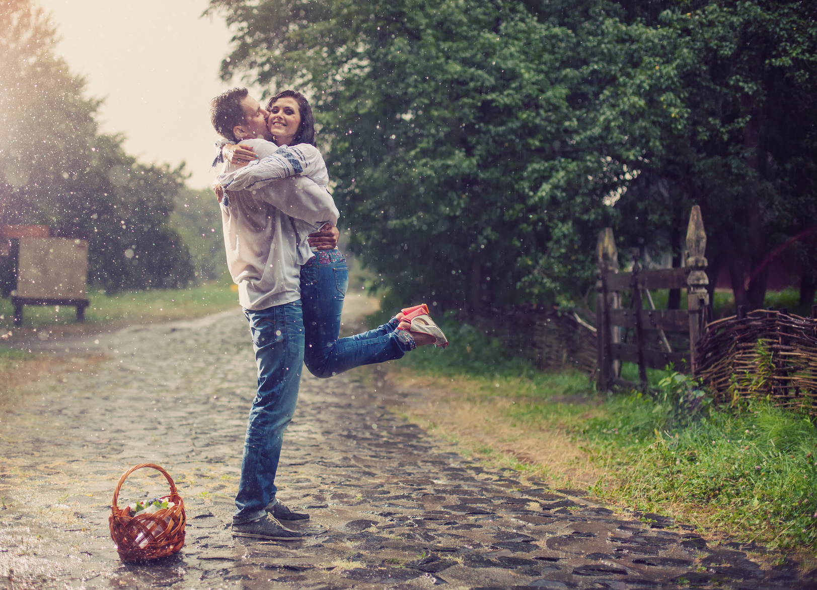 Passionate young couple in Ukrainian style clothes under rain