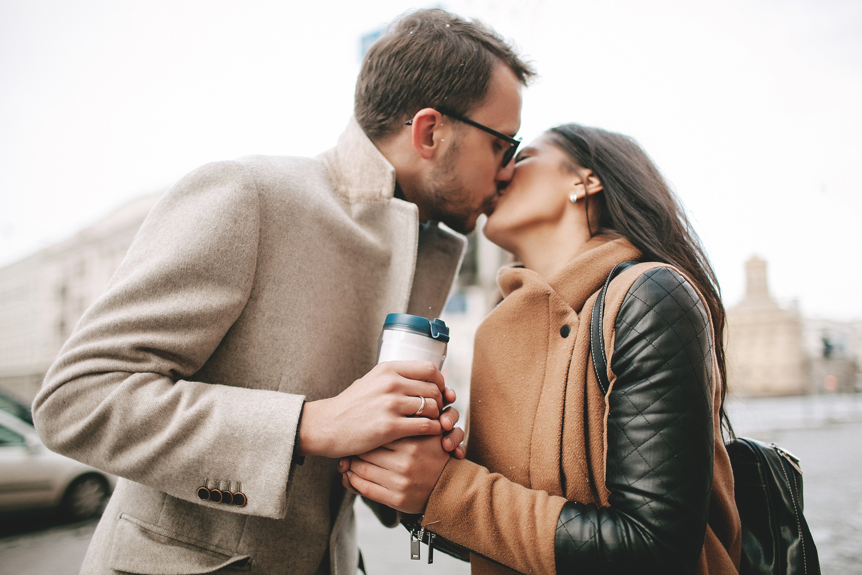 Young couple is kissing on the street