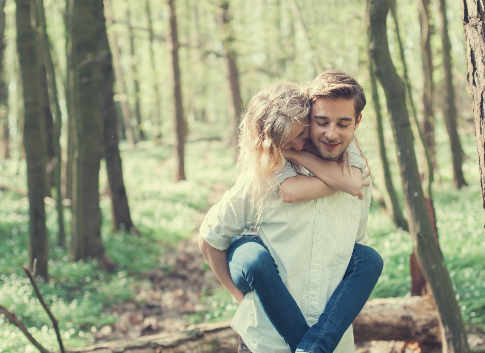 cheerful pair of lovers in summer forest