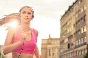 Young woman jogging in street