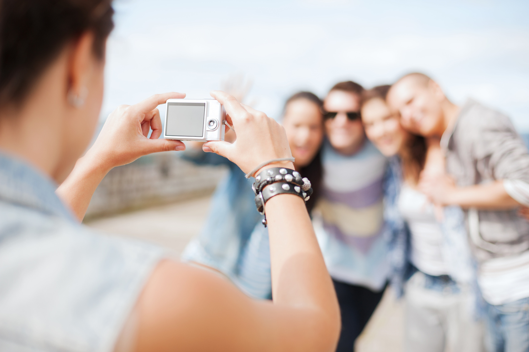 close up of female hands holding digital camera