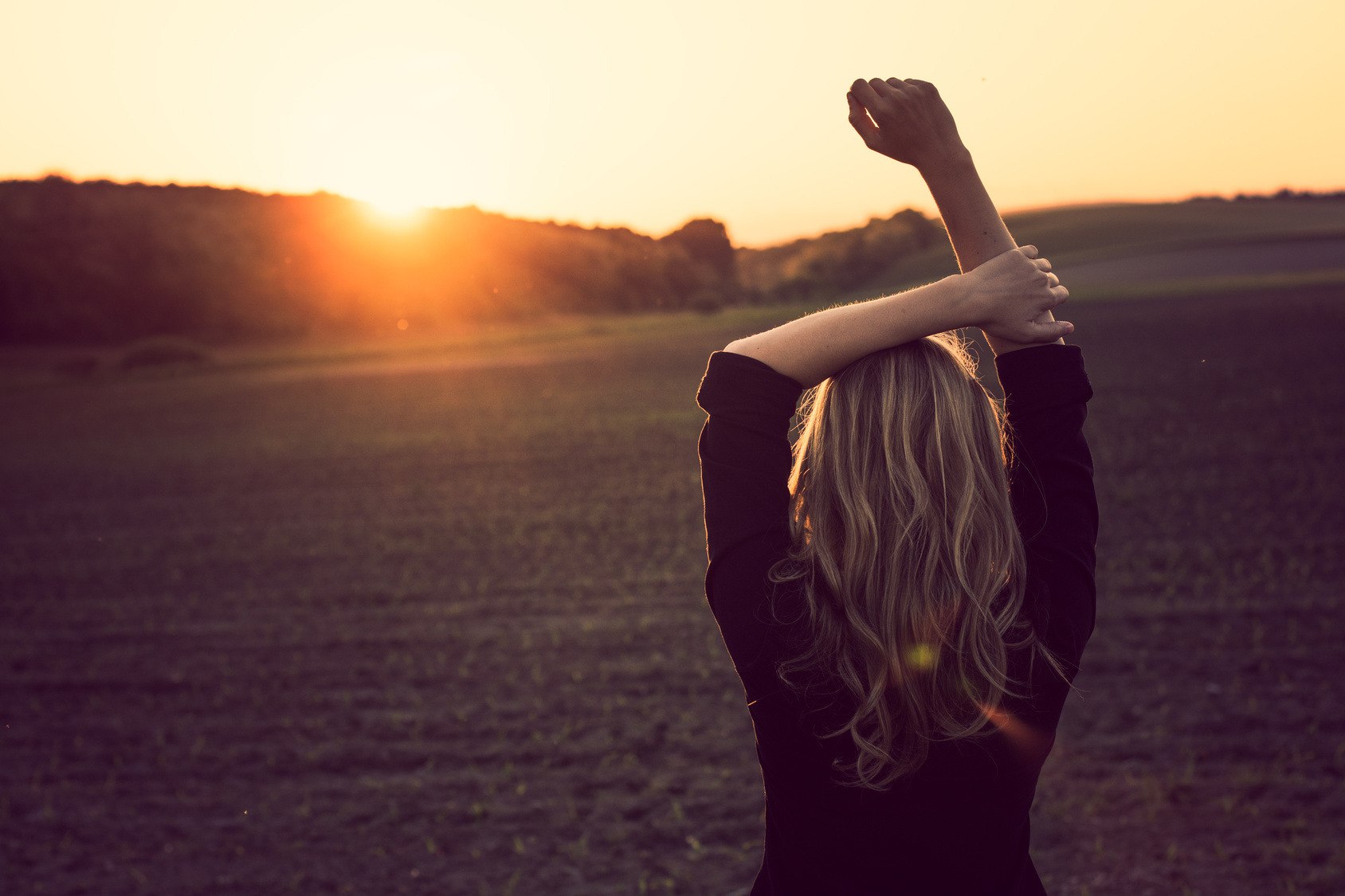 Young woman enjoys sun beams