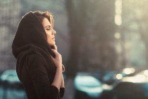 The mysterious pensive woman in a hood