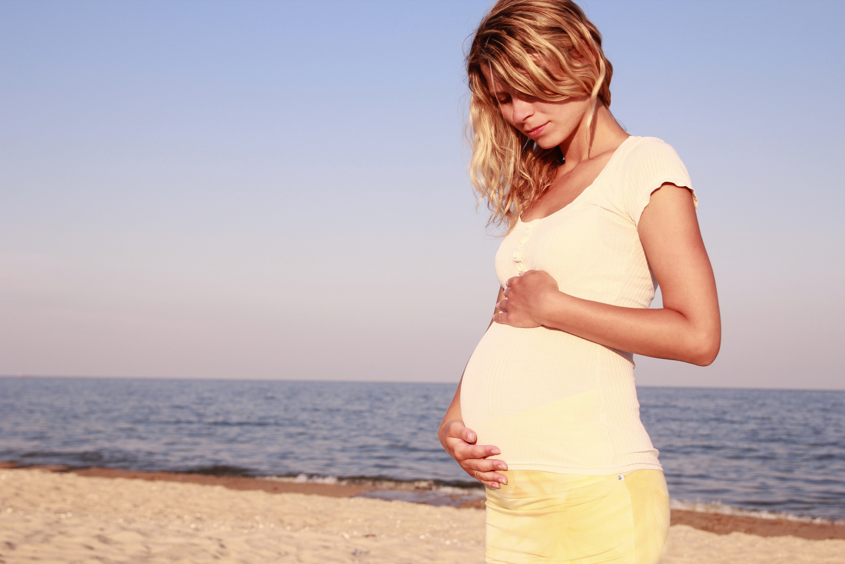 Pregnant woman on seashore