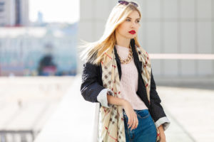Stylish fashion portrait of blonde woman. Posing in the city