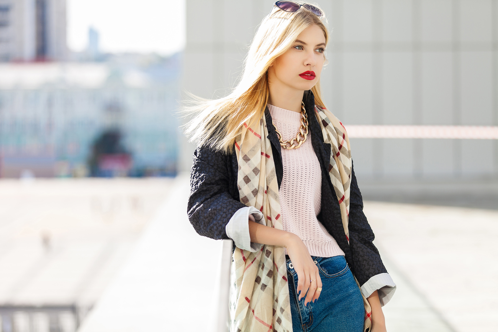 Stylish fashion portrait of blonde woman. Posing in the city