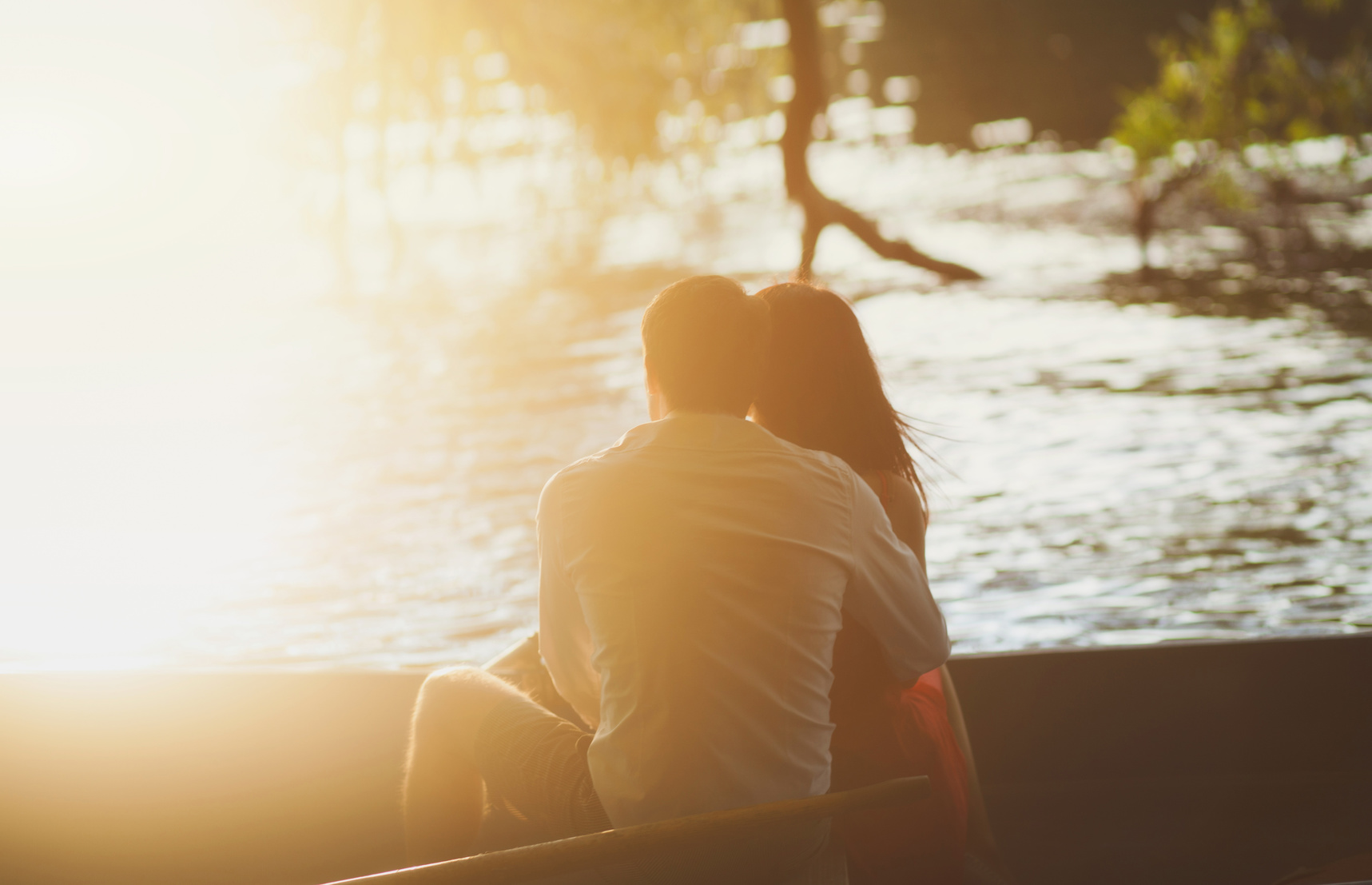 Tender couple looking at the sunset