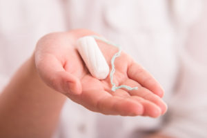 White woman’s tampon on hand