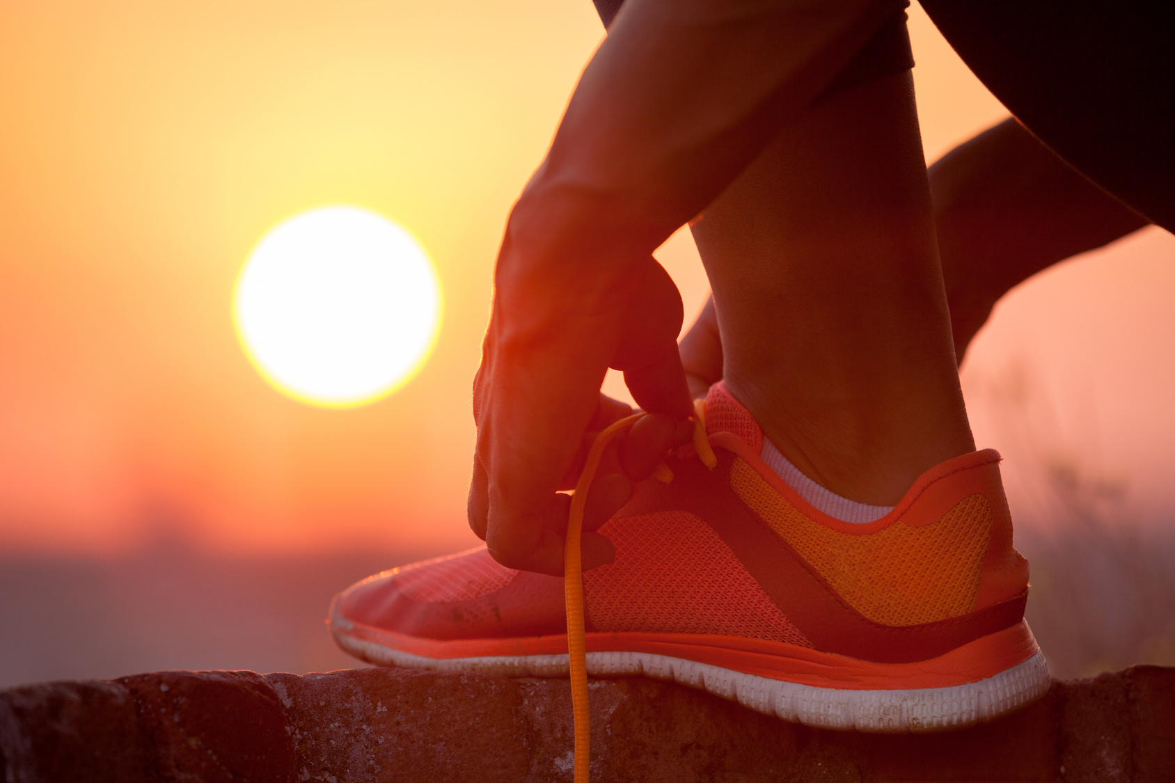 woman tying shoelaces outdoor