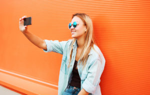 Summer, fun, technology and people concept – cool hipster girl