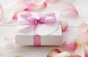 gift box with blank gift tag and flower petals
