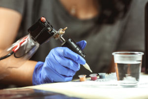 Tattooist makes a tattoo. Closeup