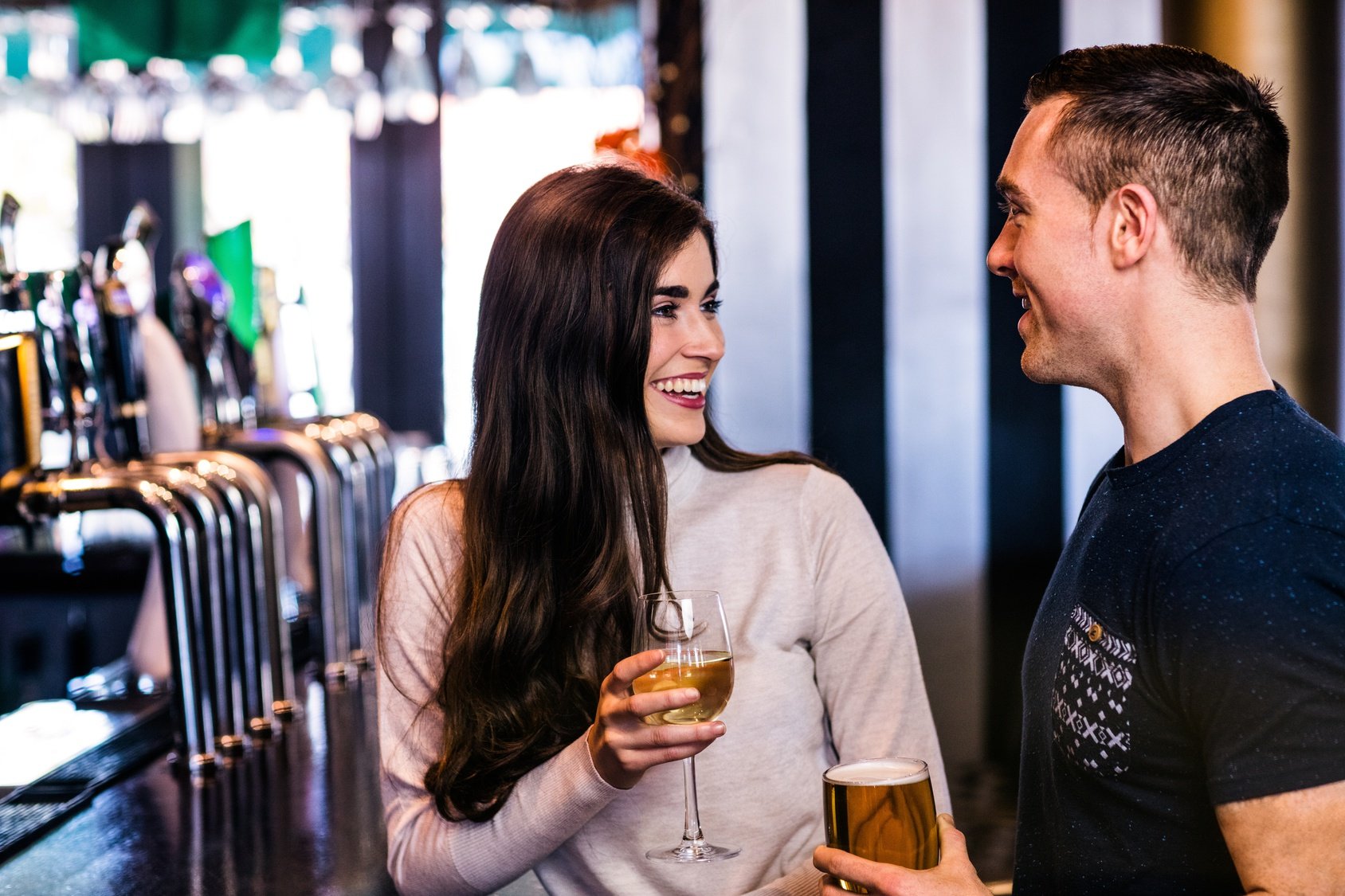 Cute couple talking in a bar