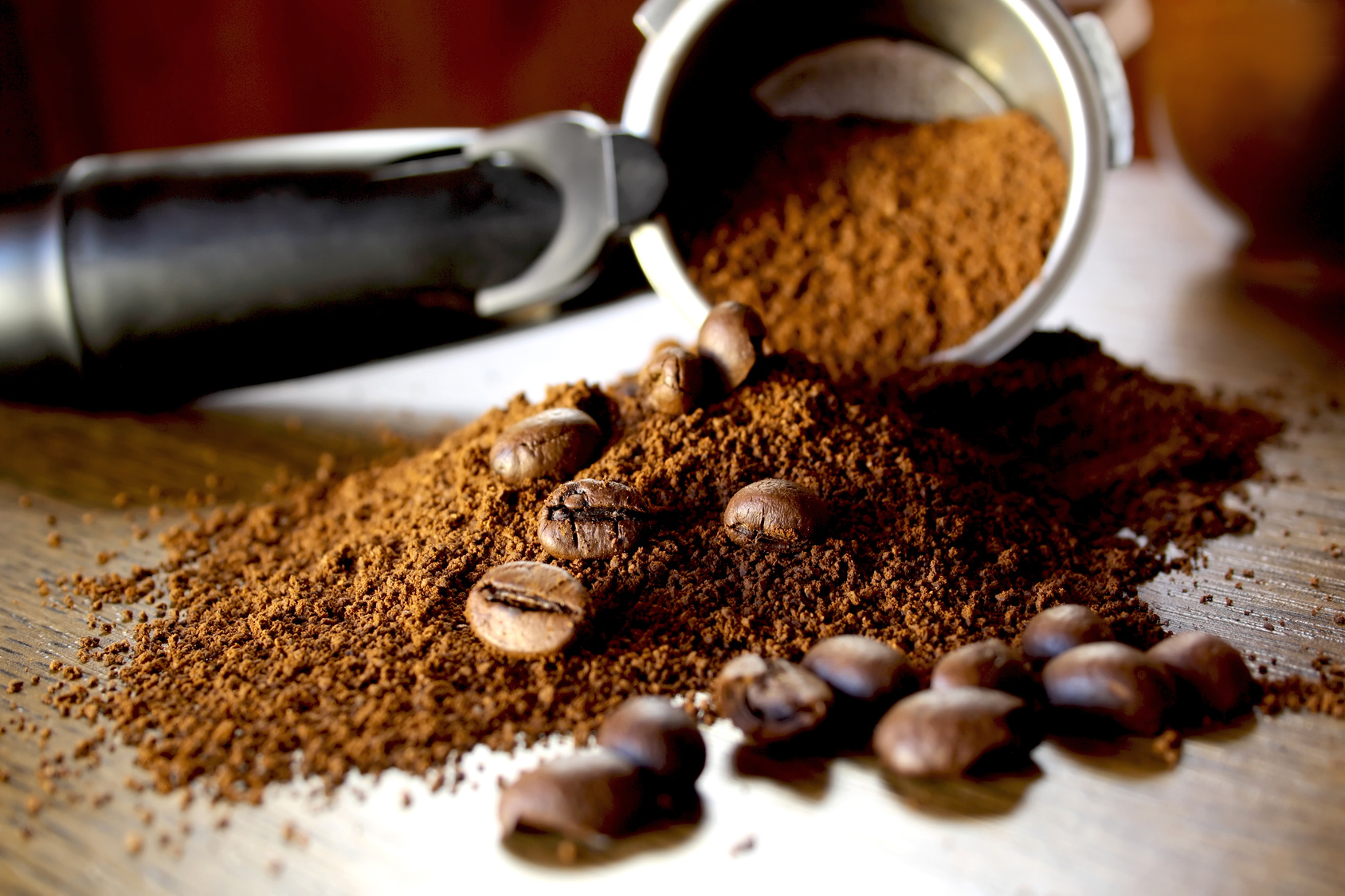 Ground coffee and beans  on wooden background