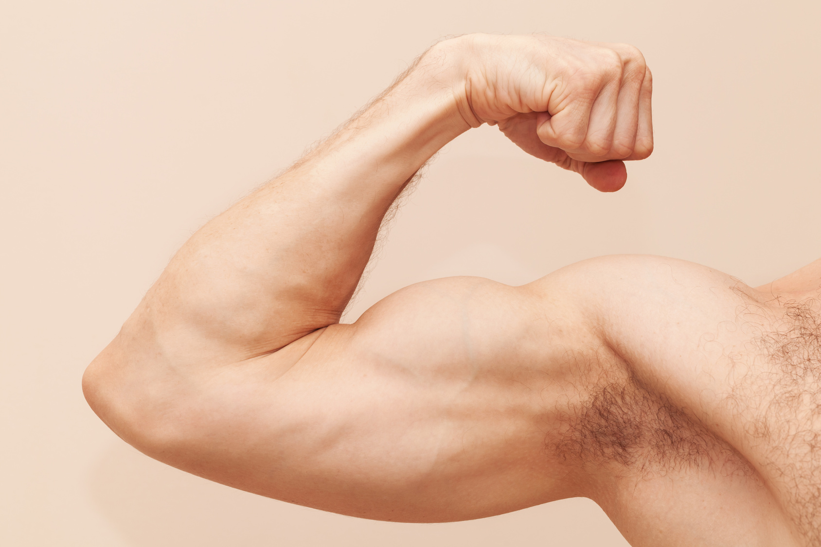 Strong male arm with biceps. Close up photo muscle fitness man body