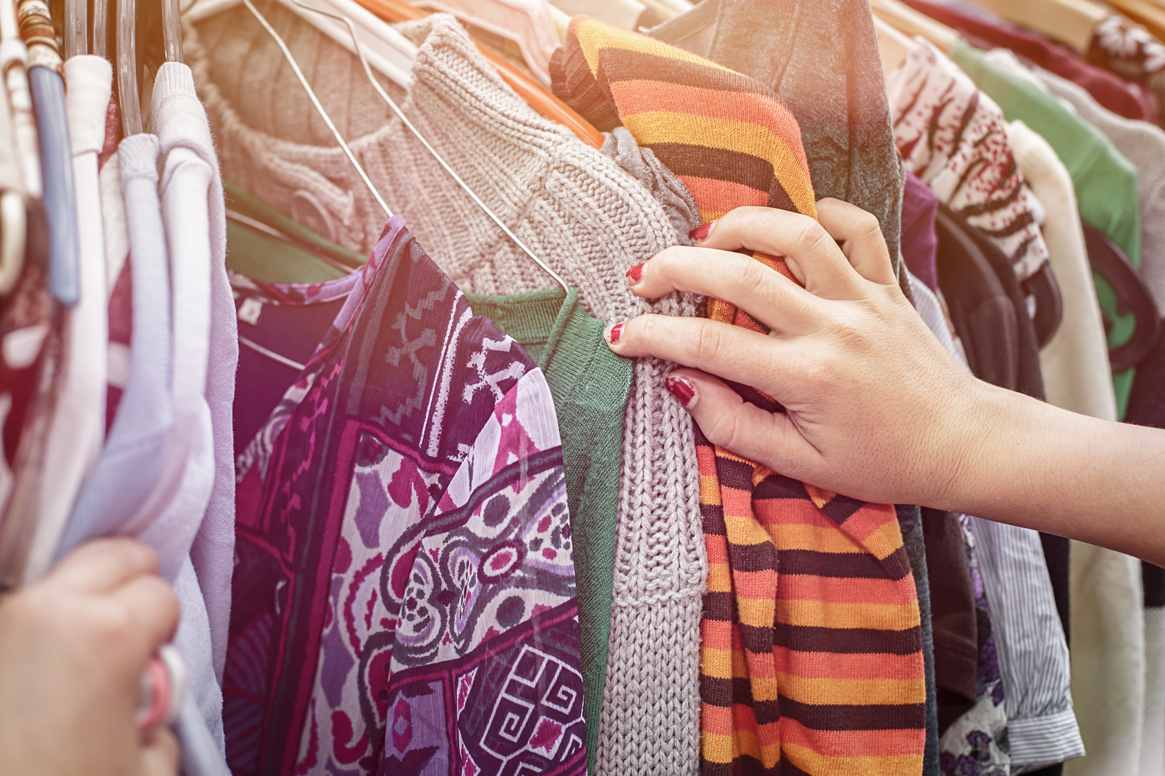 close up of a hand, looking on a flea market for clothes