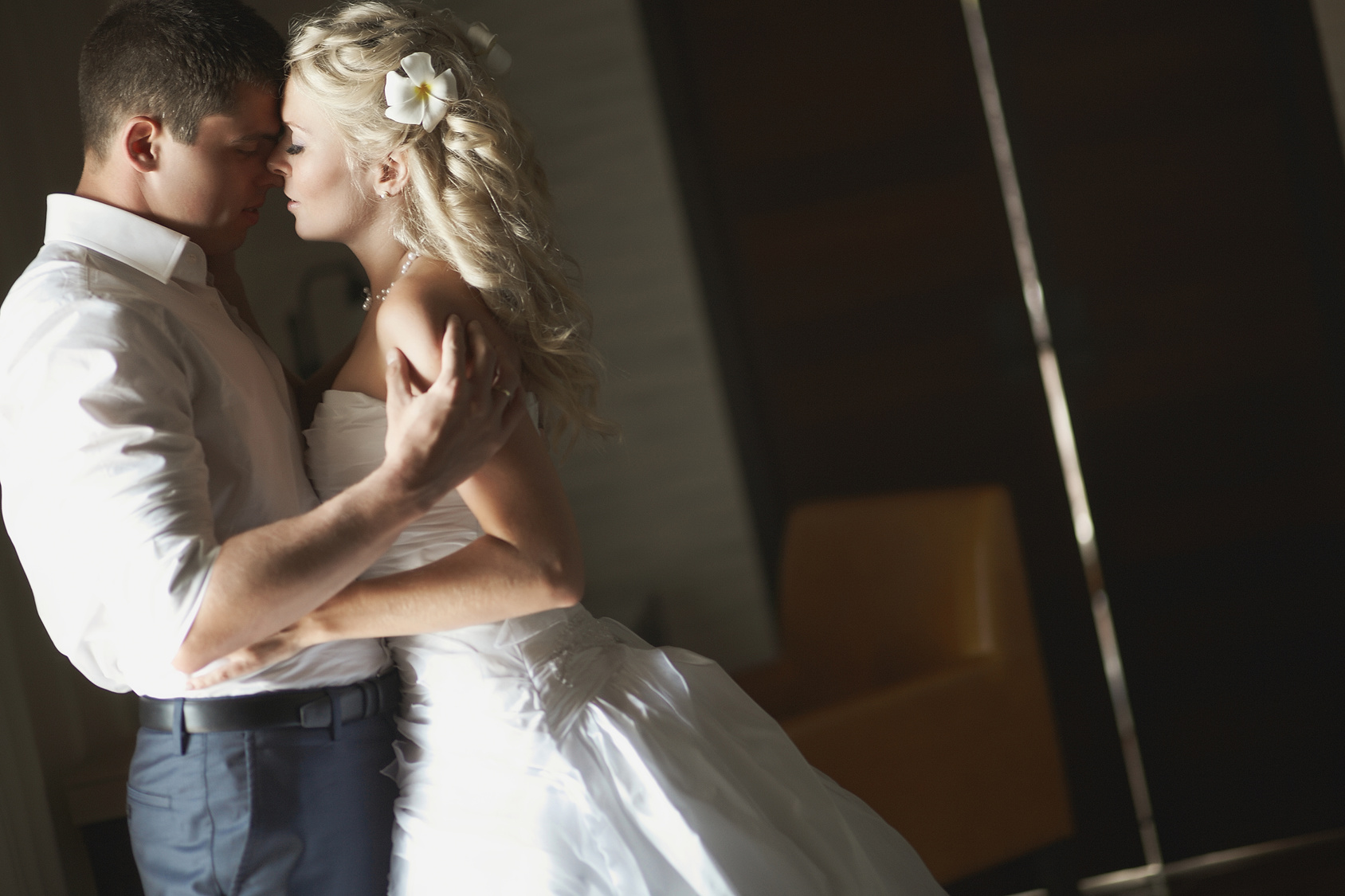 Beautiful young couple kissing with emotional embrace.