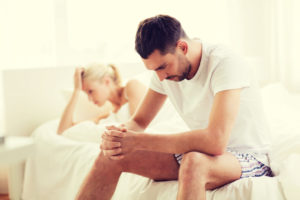 unhappy couple having problems at bedroom