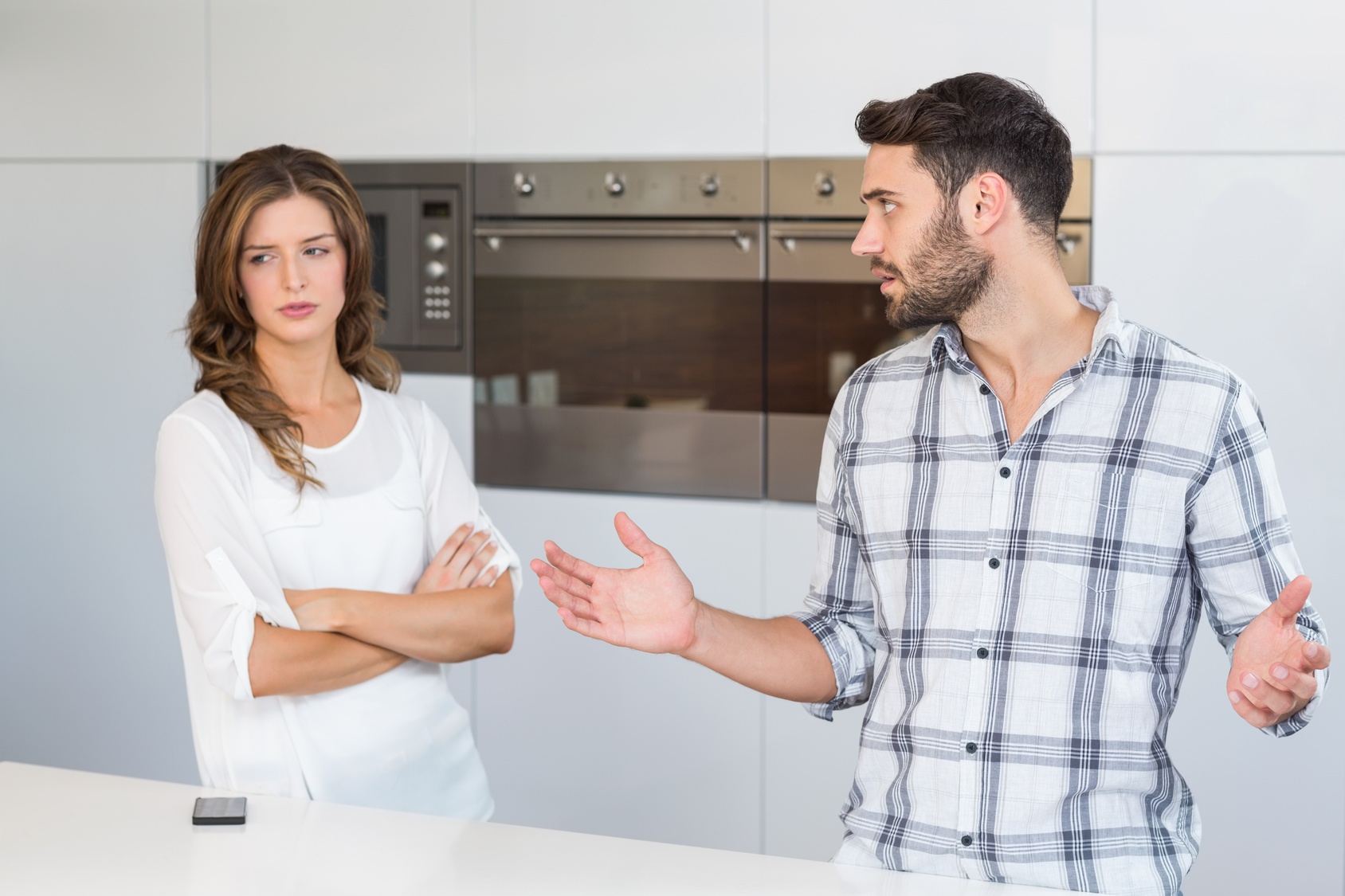 Man explaining upset woman at home