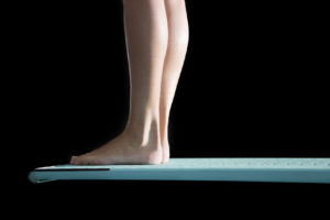 close up of feet on the trampoline blue