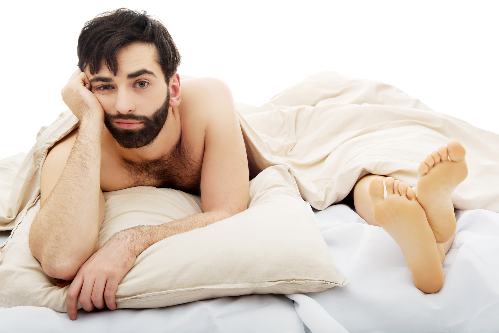 Young depressed man in bed.