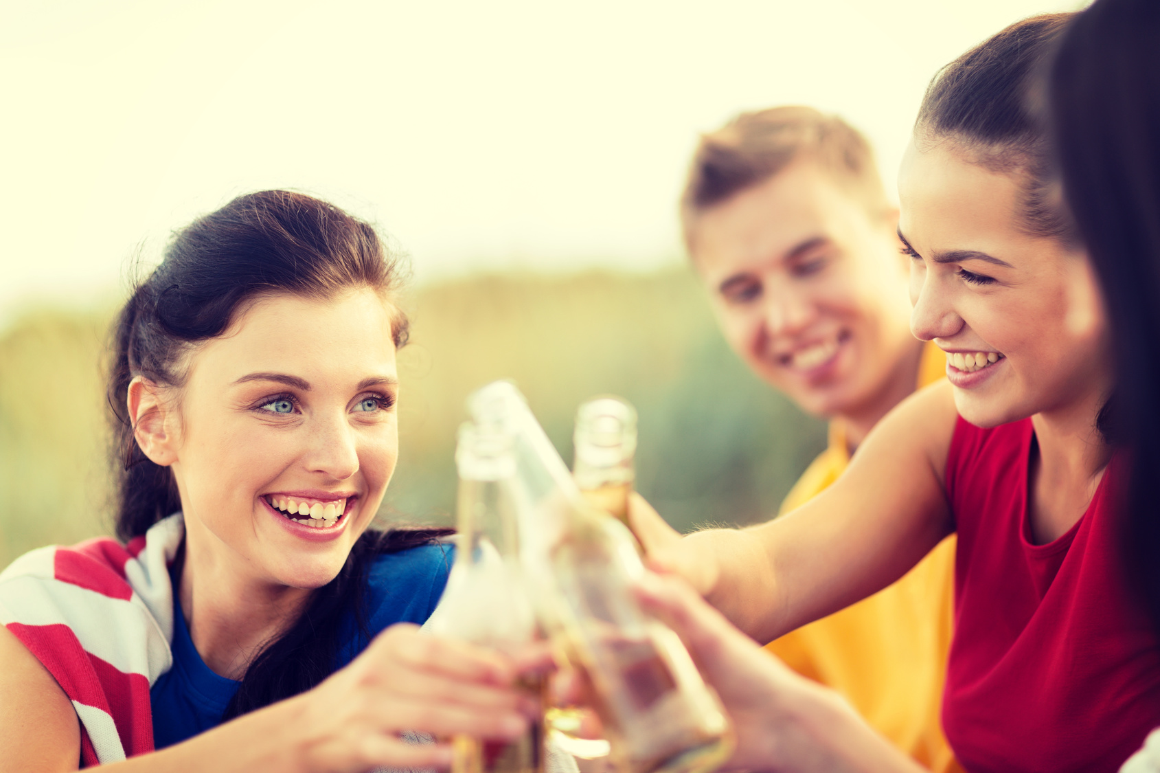 women and men with drinks on the beach