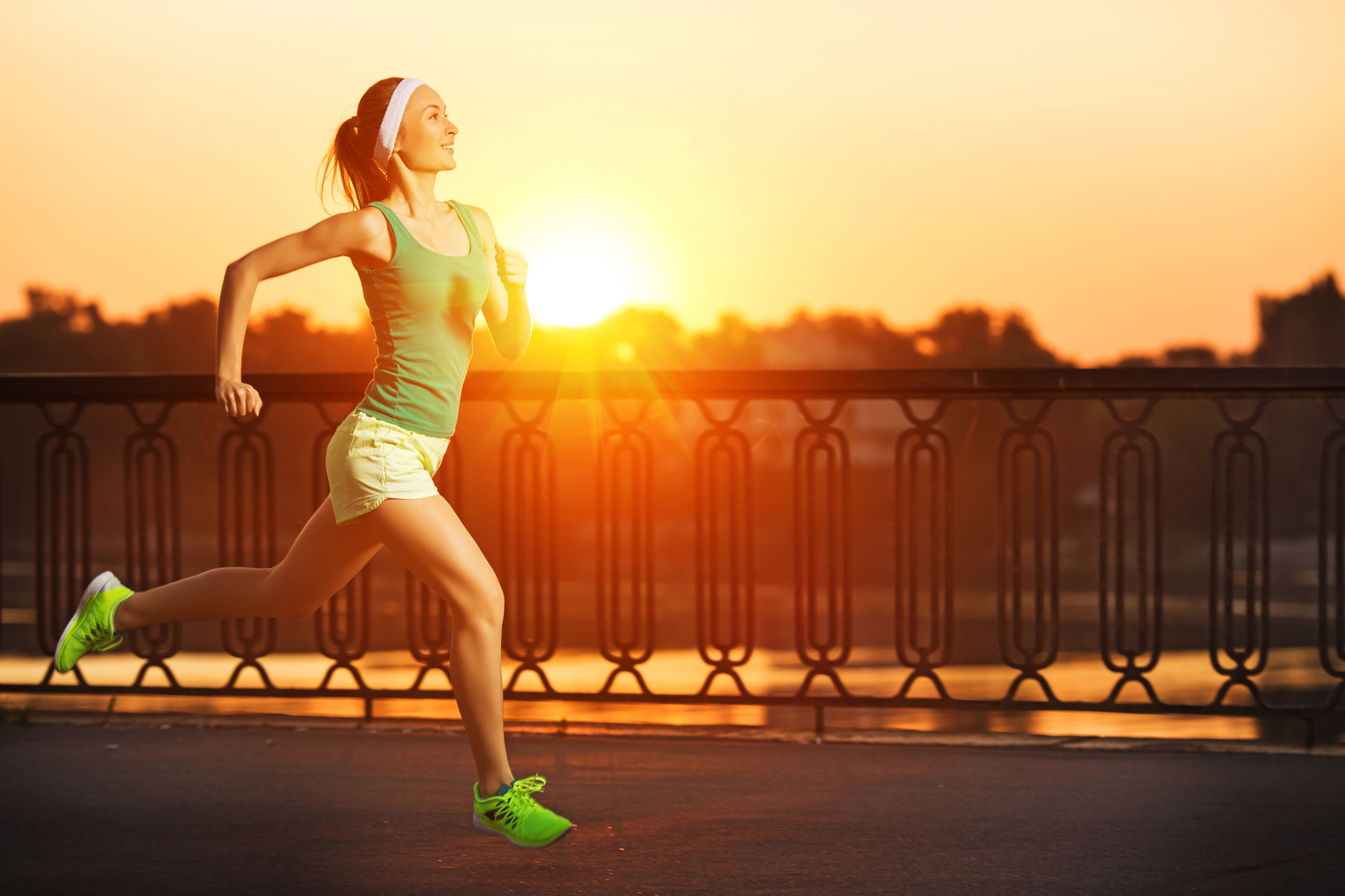 Running woman. Runner is jogging on sunrise. Female fitness