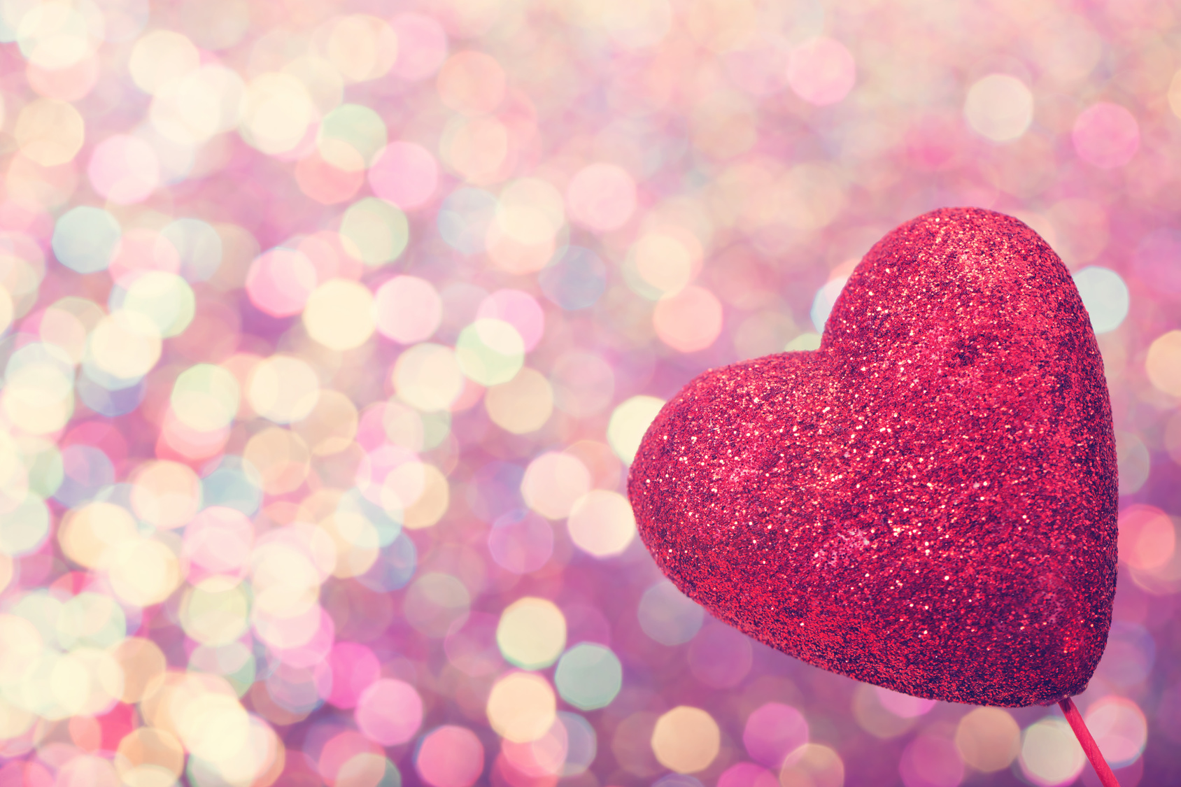Red heart on abstract shiny light background