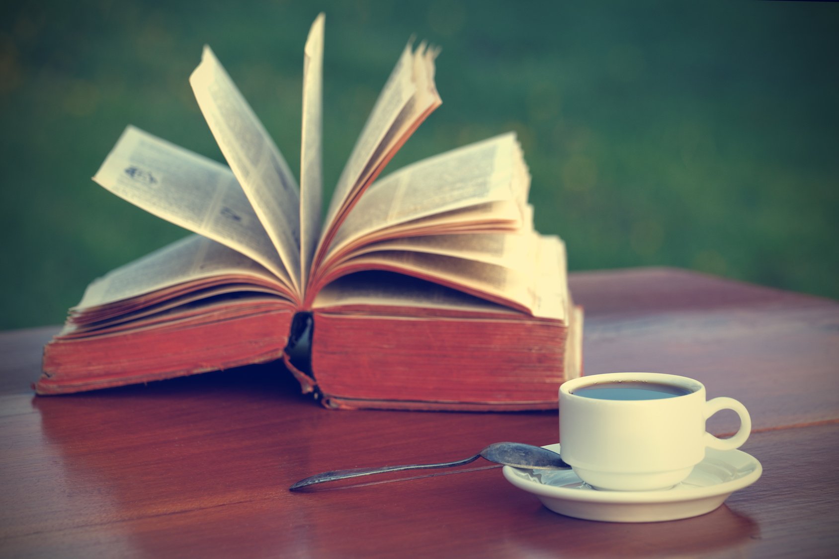 Coffee and book on wooden table-vintage filter