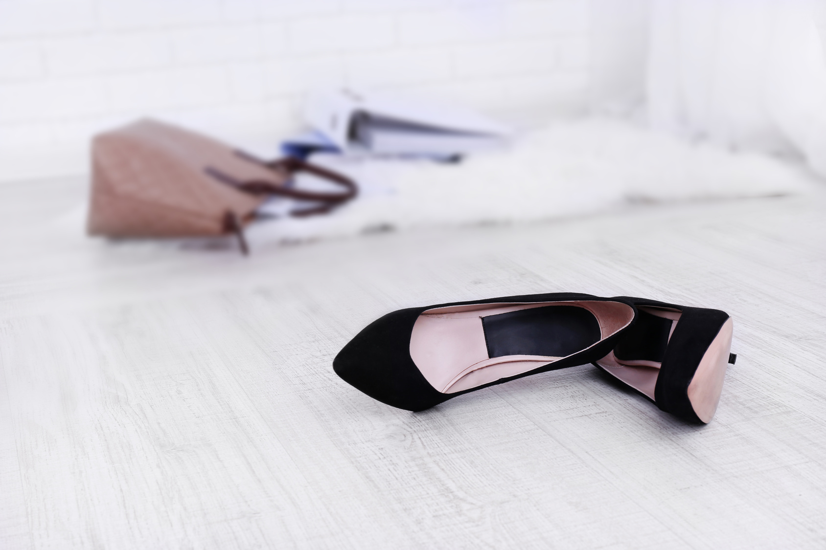 Female shoes and briefcase on floor background