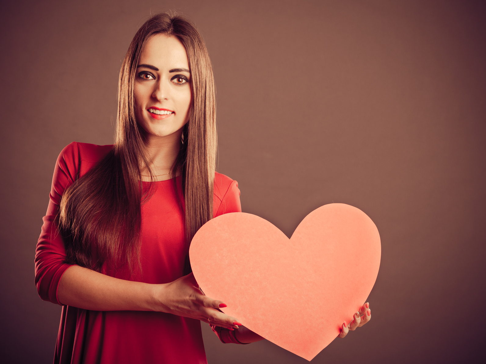 Valentines Day woman holding heart.