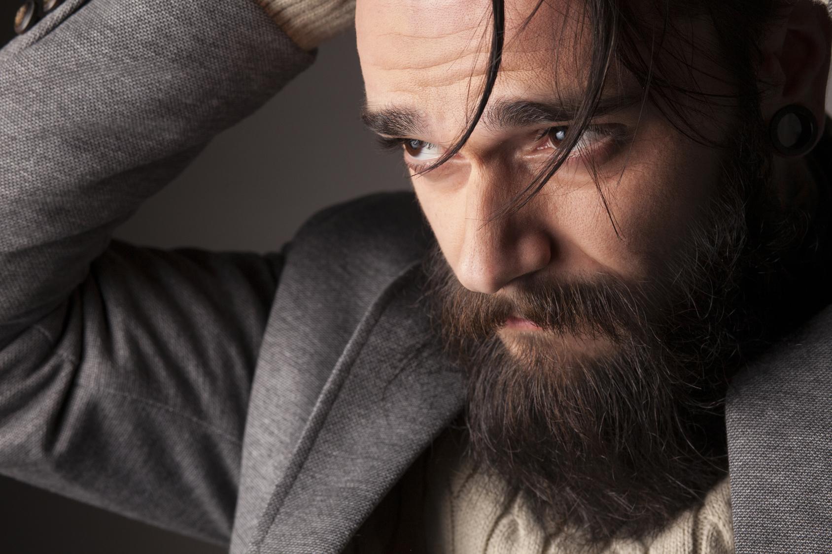 portrait of a sad young man with a beard and mustache