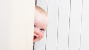 mischievous boy toddler peeking