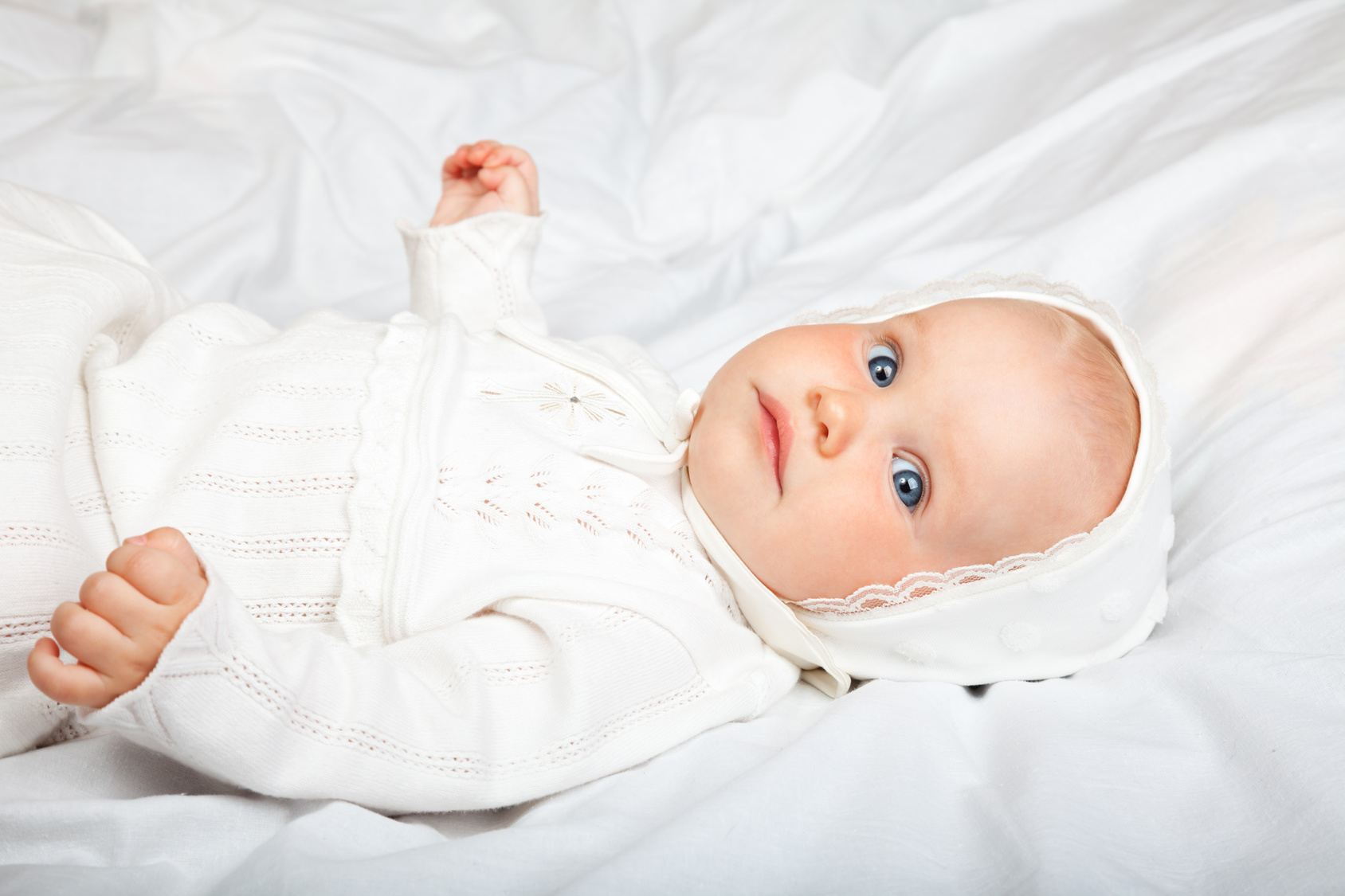 Infant in baptismal clothes