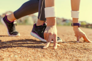 Sportswoman in running start position.