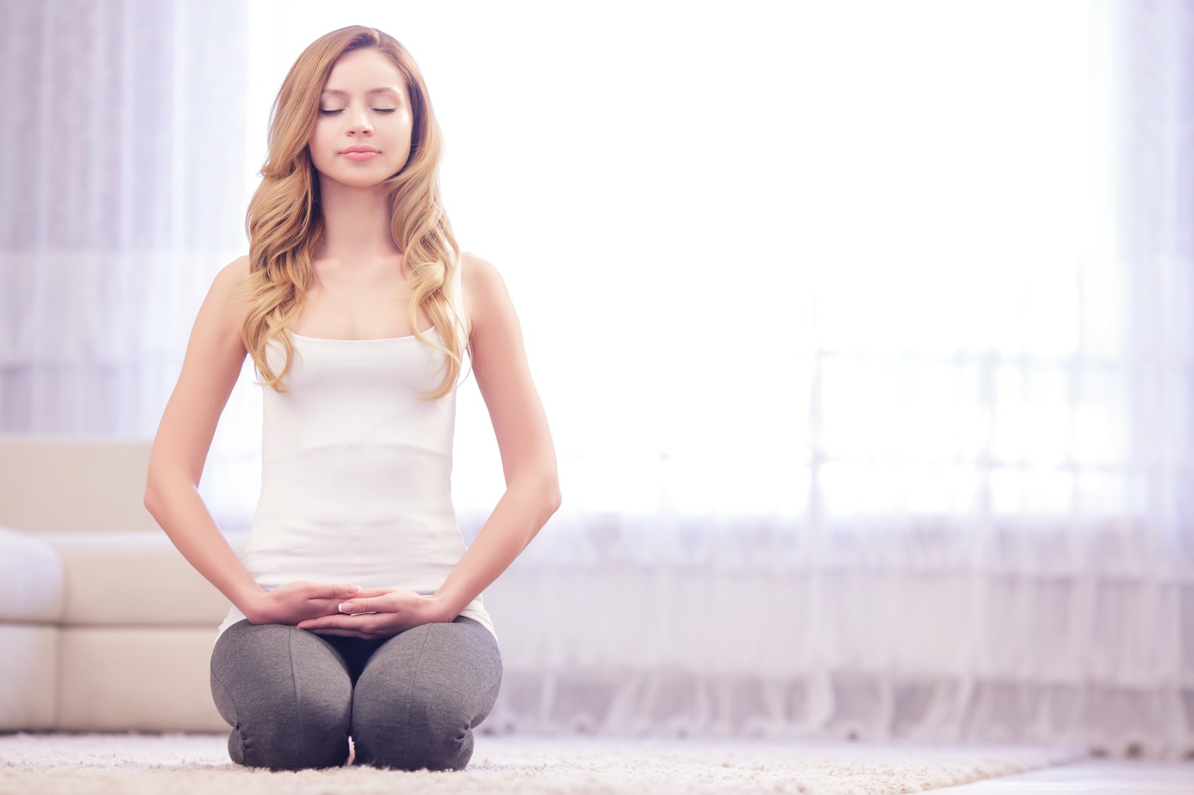 Young lady sitting on her knees